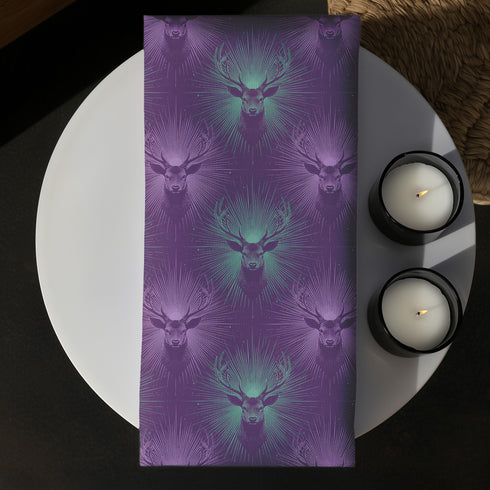 Set of four purple dining napkins featuring alternating teal and violet stag heads with radiating sunburst patterns, sized 18x18 inches.